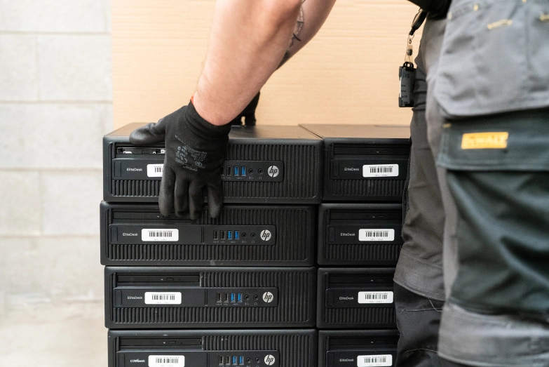 Vyta staff member moving a computer for further processing during IT Asset Disposal